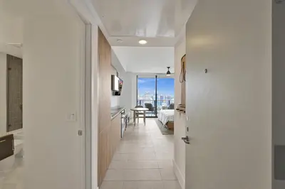 a hallway with a door leading to a bedroom at On 47th Floor! Free Parking & Views From The Top in Miami