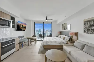a living room with a couch and a bed in it at On 47th Floor! Free Parking & Views From The Top in Miami