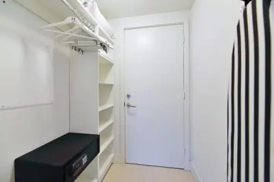 a closet with a white door and a black bench at Condo Closer The Sea and Beatiful Views in Hollywood