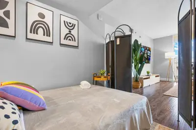 a bedroom with a bed and some pictures on the wall at The Best Amenities In One-Site in Miami