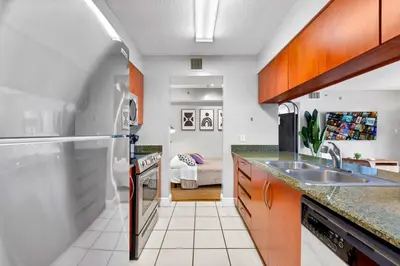 a kitchen with a sink and a refrigerator at The Best Amenities In One-Site in Miami
