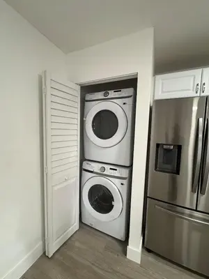 a kitchen with a washer and dryer next to a refrigerator at Modern Apartment Miami Oasis in Miami