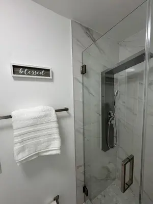 a bathroom with a shower and a towel on the wall at Modern Apartment Miami Oasis in Miami