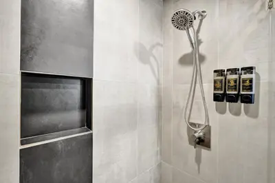 a shower with a shower head in a bathroom at Kiki 4 - Men's Clothing optional Guest Houses in Fort Lauderdale