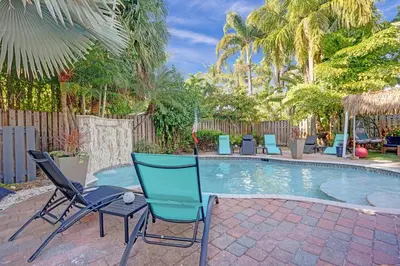 a group of chairs sitting next to a pool at Kiki 4 - Men's Clothing optional Guest Houses in Fort Lauderdale
