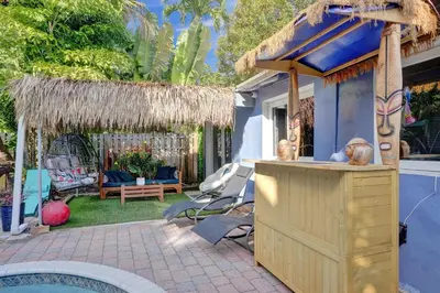 a backyard with a bar and a pool at Kiki 4 - Men's Clothing optional Guest Houses in Fort Lauderdale