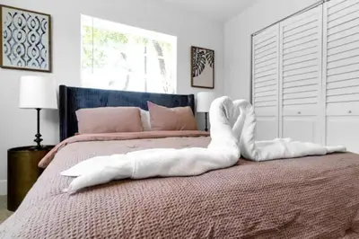 a bedroom with a bed with a white object on it at Fab 4BR Twin Villas Near Design District and Wynwood in Miami