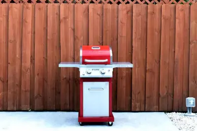 a red and white stove in front of a fence at Fab 4BR Twin Villas Near Design District and Wynwood in Miami