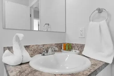 a bathroom counter with a sink and a mirror at Fab 4BR Twin Villas Near Design District and Wynwood in Miami