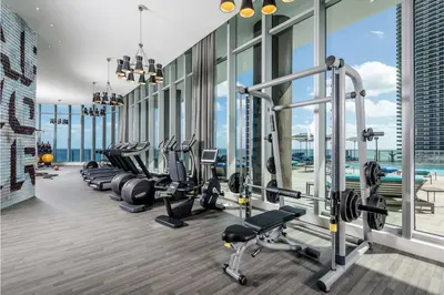 a gym with a row of treadmills and machines at Sun and Beach Closer of You! Condo All-In in Hollywood