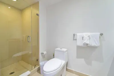 a white bathroom with a toilet and a shower at Sun and Beach Closer of You! Condo All-In in Hollywood
