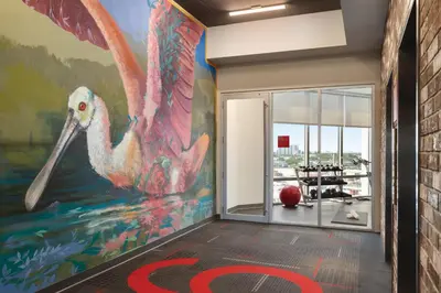 a mural of a pink flamingo in a gym at Kompose Boutique Miami Airport in Miami