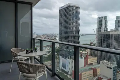 a balcony with a table and chairs and a view of a city at RumRunner - Hotel style amenities in the heart of Miami in Miami