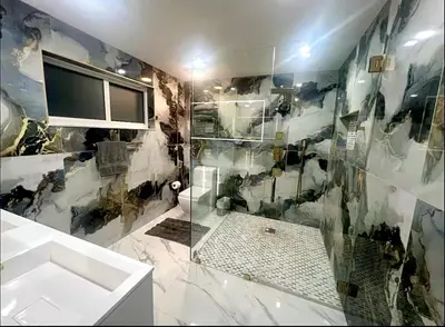 a bathroom with a shower with a sink and a tv at New! Upscale Modern waterfront apartment 3BR 3BA in Miami