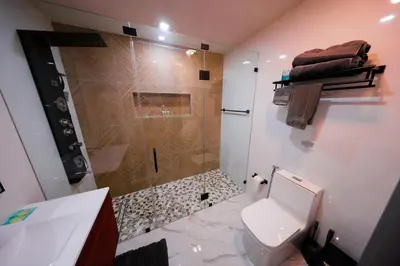 a bathroom with a shower and a toilet and a sink at New! Upscale Modern waterfront apartment 3BR 3BA in Miami