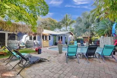 a patio with chairs and a swimming pool at Kiki 5 - Men's Clothing optional Guest Houses in Fort Lauderdale