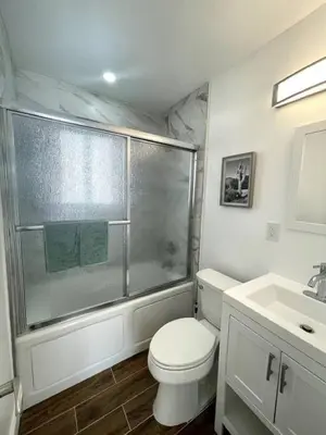a bathroom with a shower and a toilet and a sink at Modern Studio W Parking 10 min to FLL and Beach in Hollywood