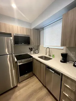 a kitchen with a stainless steel refrigerator and a sink at Las Olas Studio W Parking 10 min to FLL and beach in Hollywood