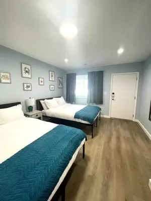 a hotel room with two beds and a window at Las Olas Studio W Parking 10 min to FLL and beach in Hollywood