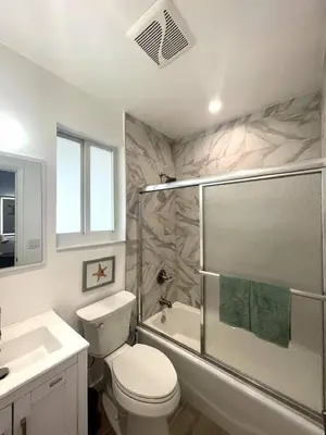 a bathroom with a toilet and a shower and a sink at Las Olas Studio W Parking 10 min to FLL and beach in Hollywood