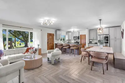 a living room with a couch and a table at Pickleball fun Family home near Hard Rock Stadium in North Miami