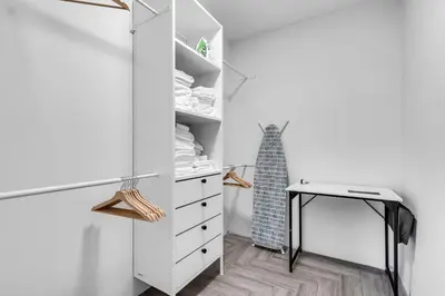 a closet with a desk and a white cabinet at Pickleball fun Family home near Hard Rock Stadium in North Miami