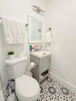 a bathroom with a white toilet and a sink at Apartament Miami Design District in Miami