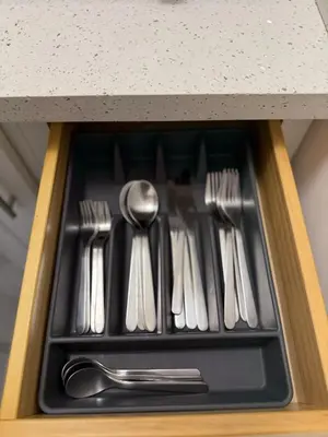 a drawer filled with silver utensils on a counter at Apartament Miami Design District in Miami