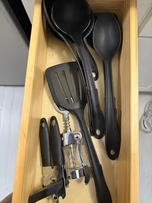 a wooden drawer with utensils in a wooden box at Apartament Miami Design District in Miami