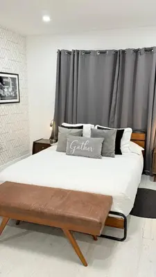 a bedroom with a large bed with a wooden frame at Apartament Miami Design District in Miami