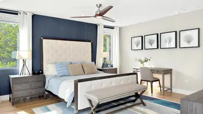 a bedroom with a bed and a desk and a ceiling fan at Lux 4BR Retreat with Heated Pool, BBQ, and Bikes in Miami