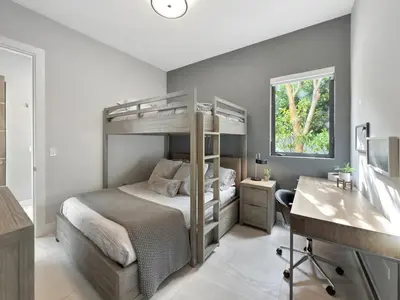 a bedroom with a bunk bed and a desk at Lux 4BR Retreat with Heated Pool, BBQ, and Bikes in Miami