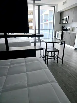 a living room with a bed and a table and a couch at Miami Myami Miamí Studio Apartment with Balcony in Miami