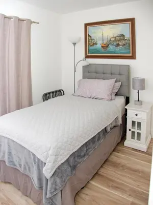 a bedroom with a bed and a painting on the wall at Welcome to Miami Springs Charm in Miami