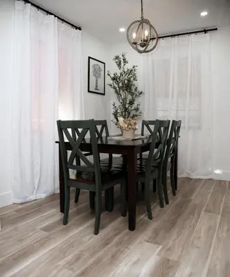 a dining room table with chairs and a chandelier at Welcome to Miami Springs Charm in Miami