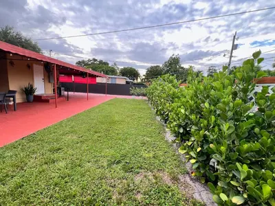 a row of bushes in front of a building at Welcome to Miami Springs Charm in Miami