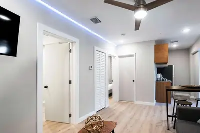 a living room with white walls and a ceiling at Prestige Brickell Miami Suite in Miami