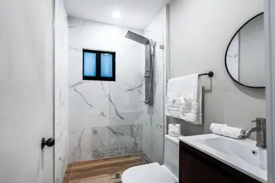 a bathroom with a shower and a toilet and a sink at Prestige Brickell Miami Suite in Miami