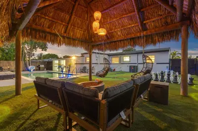 a ping pong table in a backyard with a pool at Cozy Miami Private Pool House W- Arcade Games, BBQ in Norland