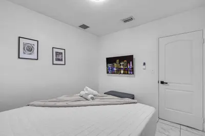 a white bedroom with a bed with a teddy bear on it at Cozy Miami Private Pool House W- Arcade Games, BBQ in Norland