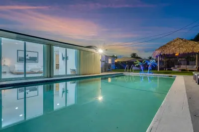 a swimming pool in a house at night at Cozy Miami Private Pool House W- Arcade Games, BBQ in Norland