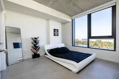 a bedroom with a large bed and large windows at The Chill Spot in Miami