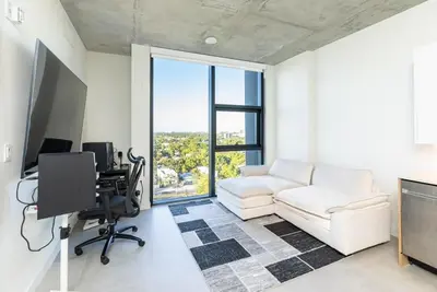 a living room with a white couch and a desk at The Chill Spot in Miami
