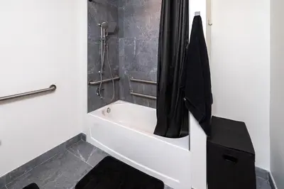 a bathroom with a bath tub with a shower curtain at The Chill Spot in Miami