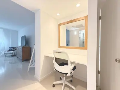 a white desk with a white chair in a room at 1 SPRING PROMO - Sunny Isles Seaview Condo, Walk to Beach, Amazing Amenities in Sunny Isles Beach