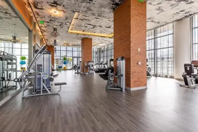 a gym with treadmills and machines in a room at Corner Modern Ocean View Low Floor in Hollywood