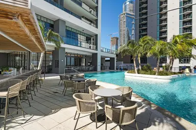 an outdoor patio with tables and chairs next to a swimming pool at 37th Floor - 1bdrm Unt amazing View at Downtown Miami in Miami