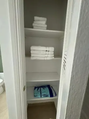 a closet with white towels and towels at Spacious Apt Ocean Reserve Resort Amenities in Sunny Isles Beach