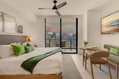 a bedroom with a bed and a table and a window at Stylish Studio -Amenities & Pool in Miami