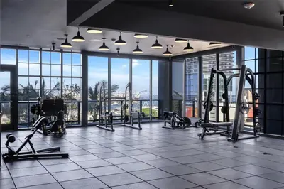 a gym with treadmills and machines in a building at Great Studio Pool Gym & Views in Miami